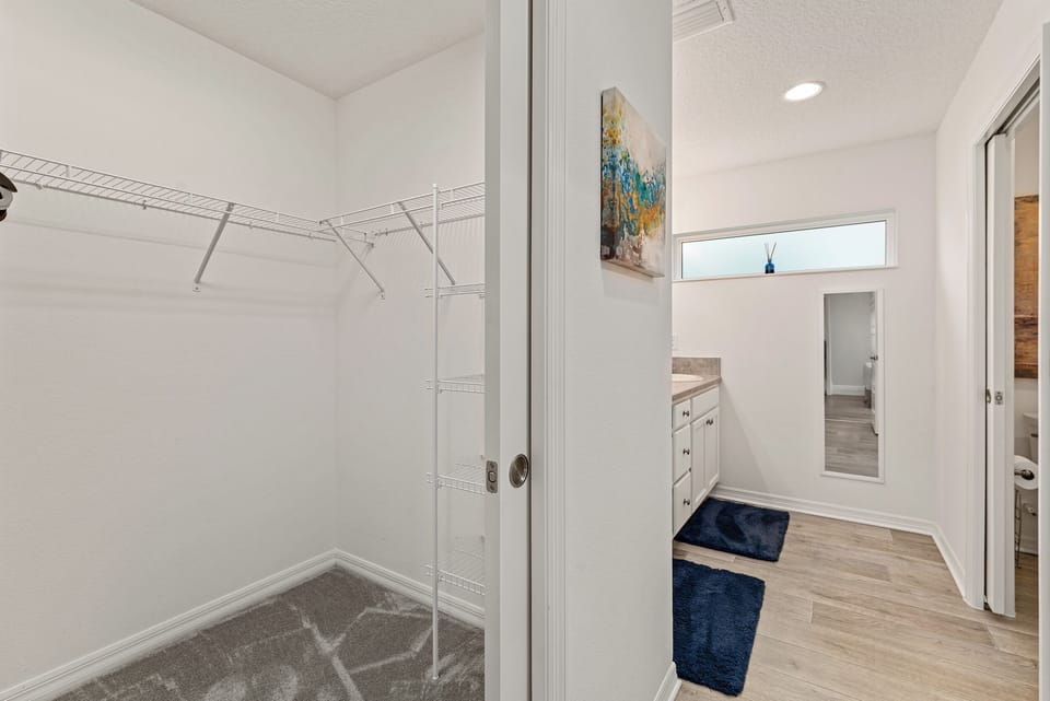 Walking into the Master Bath w/ Large Walk-in Closets on Either Side
