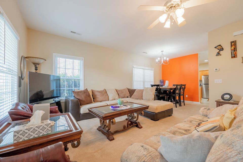 Bright lounge with sectional sofa and TV