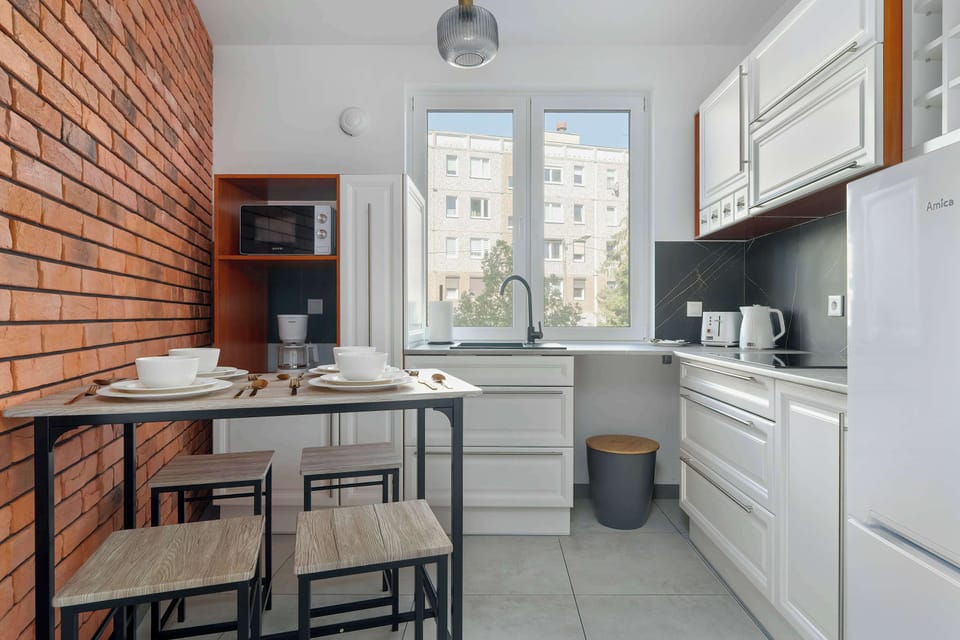 The kitchen's sleek design includes all necessary cookware and utensils.