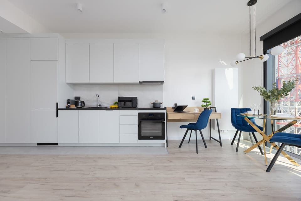 Kitchenette with oven and refrigerator. 