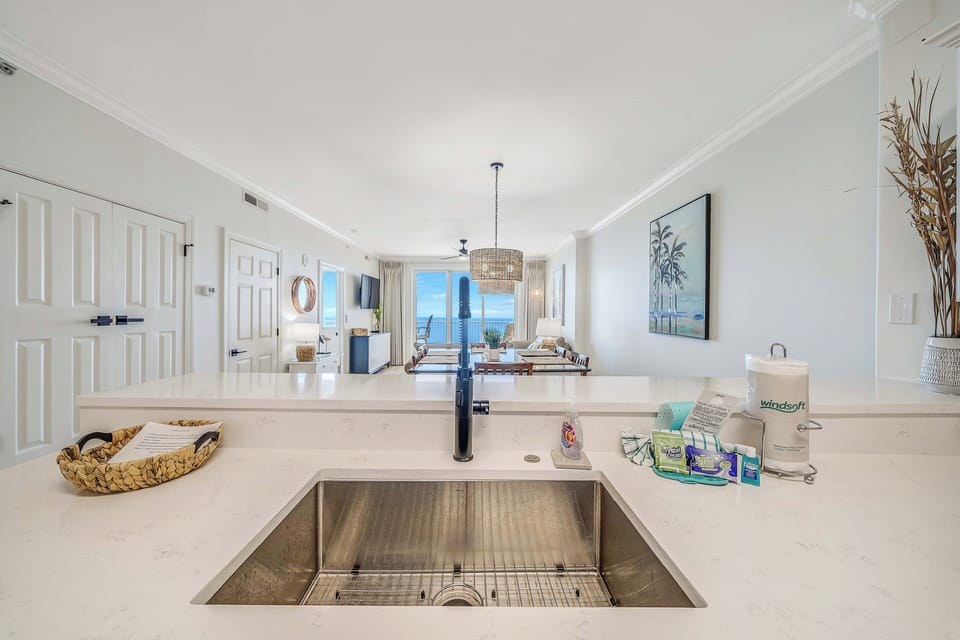 The fully equipped kitchen features quartz countertops, stainless-steel appliances, and has everything you need to prepare meals for family & friends.