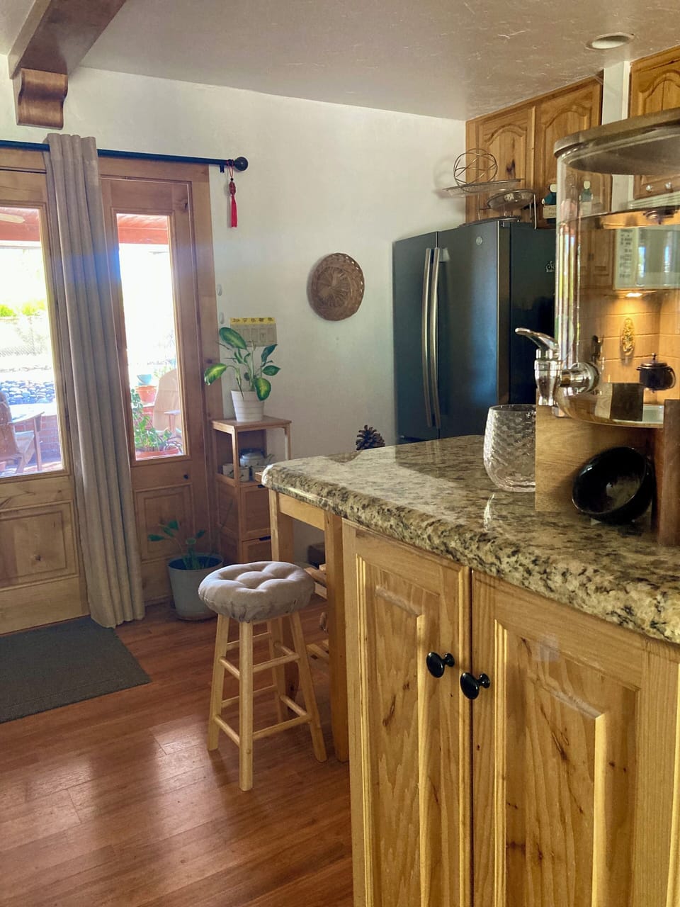 Kitchen (to right, with large refrigerator) and French door to covered patio