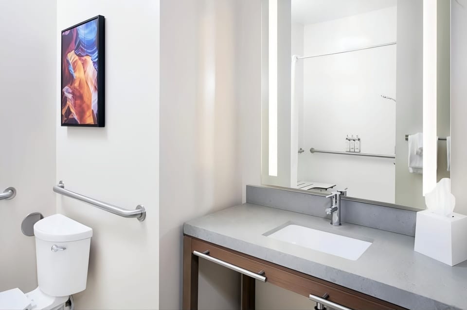 Start mornings smoothly with sleek sink, lighting, and fresh towels.