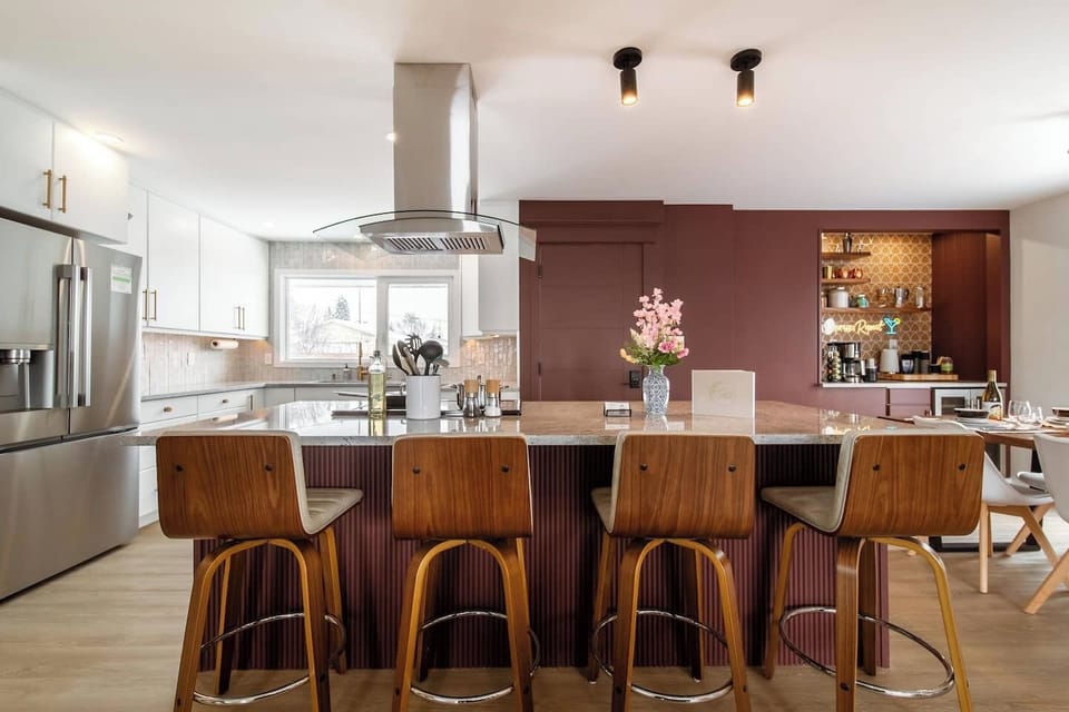 Gather around the kitchen island for a morning coffee or late-night snack. The bar seating makes it easy to mingle while meals are prepared.