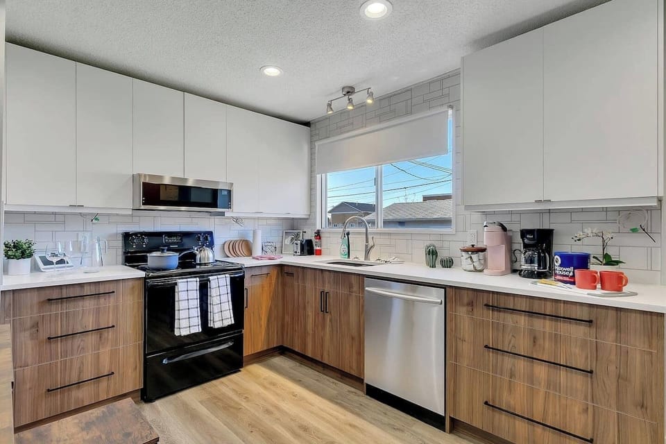 Whip up your favorite meals in this fully stocked modern kitchen, featuring sleek appliances, plenty of counter space, and a cozy coffee station to start your mornings right.