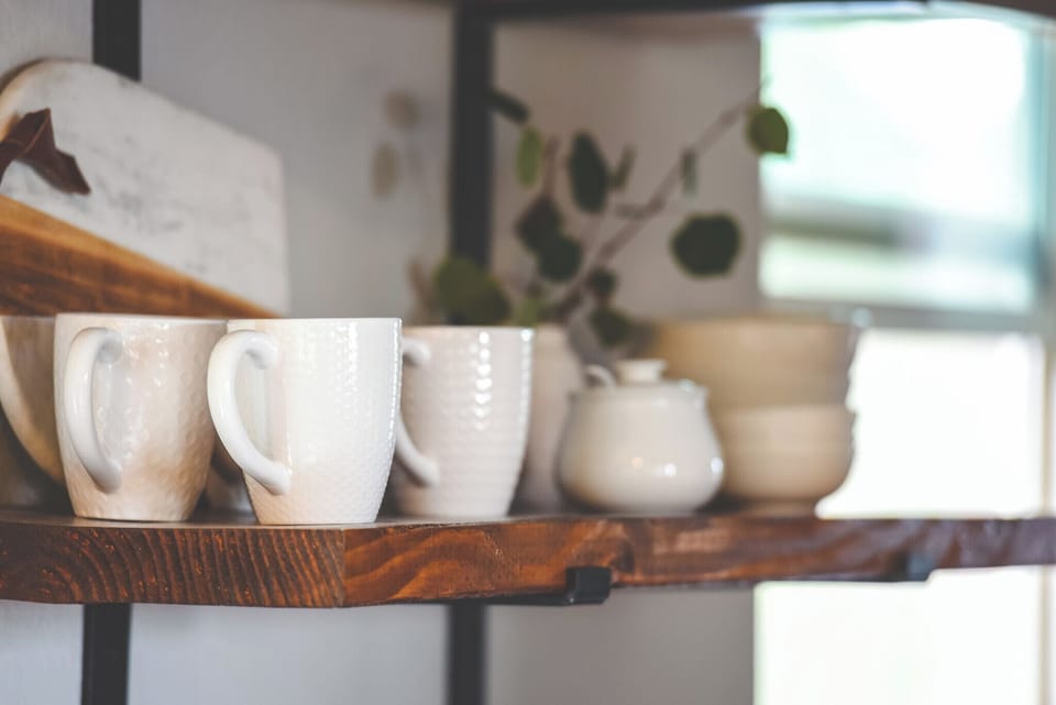 Open shelves hold mugs and bowls.