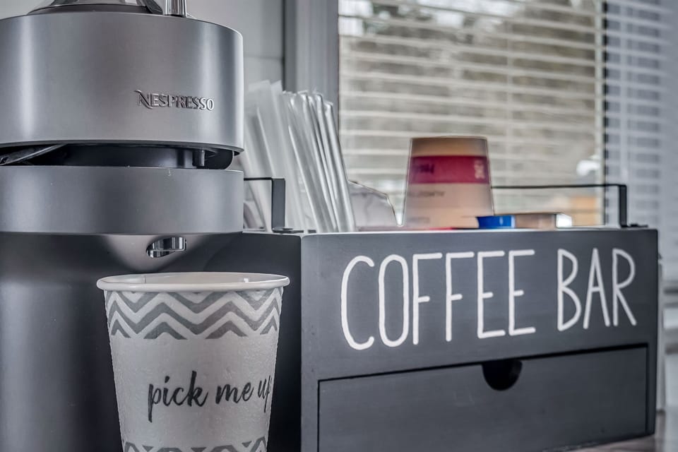 Coffee bar has NESPRESSO machine and milk frother. Also included are hot cocoa packets, creamer, tea, honey sticks and other surprises.