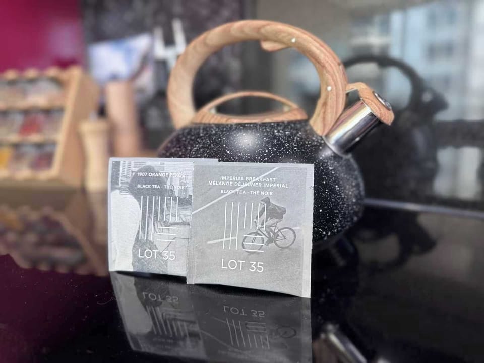 A cozy kitchen touch featuring a sleek black kettle with a wood handle and premium LOT 35 teas. Stylish and inviting, it’s the perfect setup for enjoying a warm cup while taking in the city views.