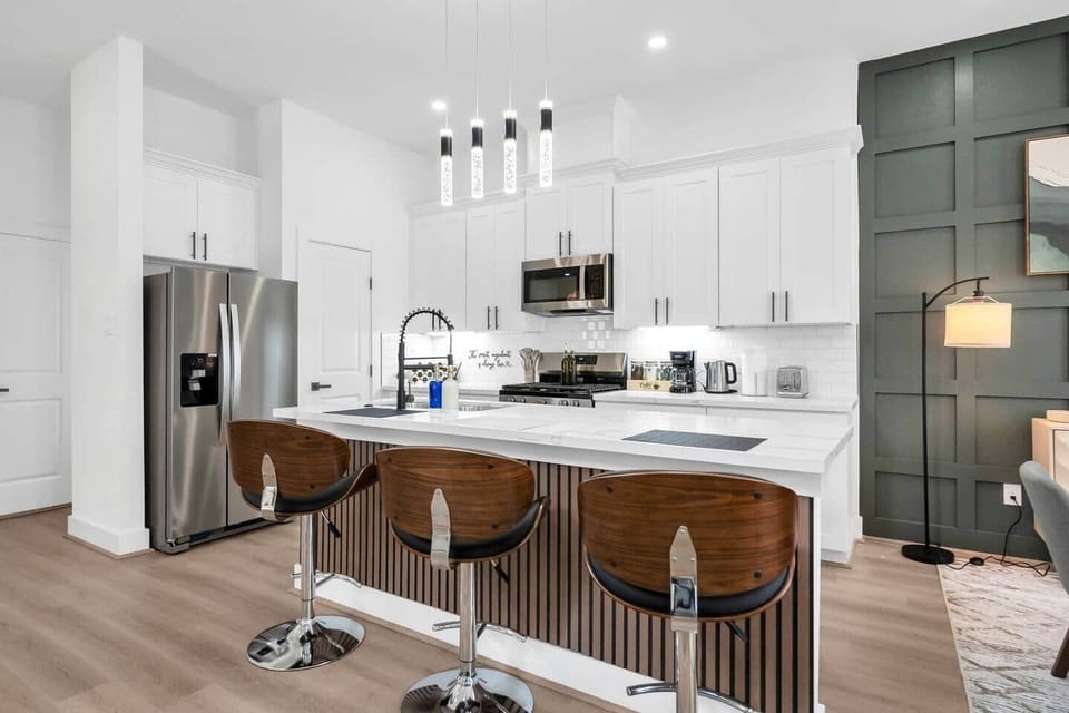 The spacious island offers plenty of room for prepping snacks or sharing breakfast together, with three comfy bar stools ideal for casual dining.
