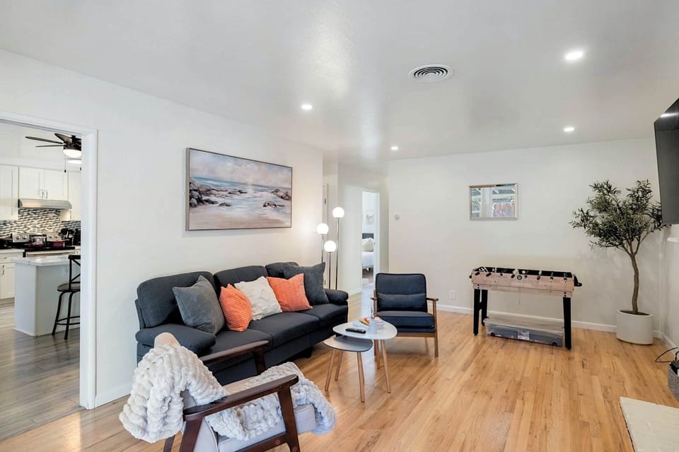 Living room view showing kitchen entrance and seating area.