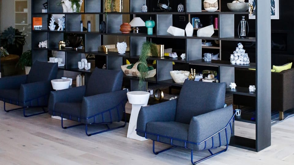 Relax in designer lounge chairs surrounded by curated decor.