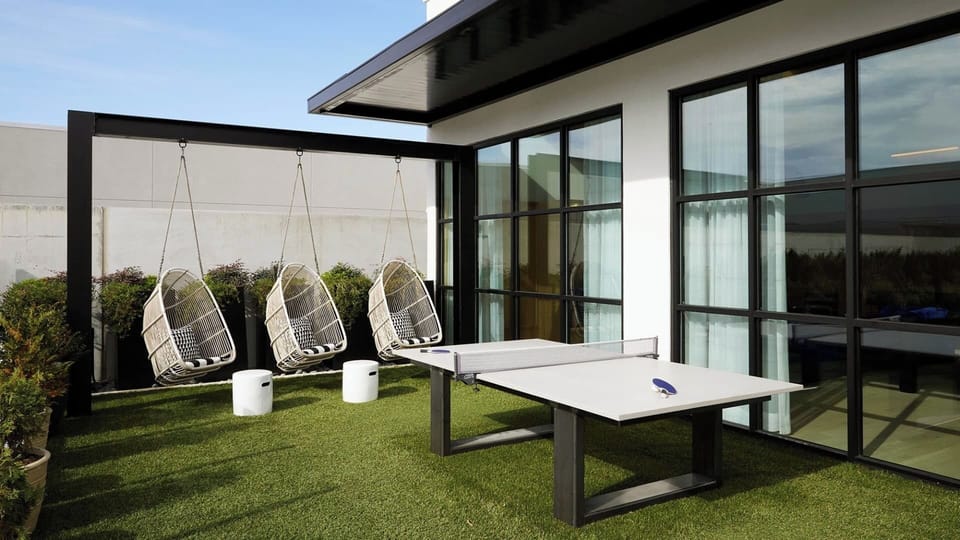 Play and lounge outdoors with swings and table tennis.
