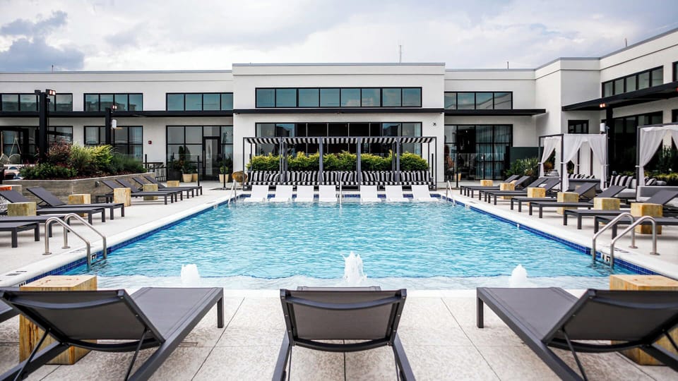 Dive into a chic pool escape with luxe loungers.