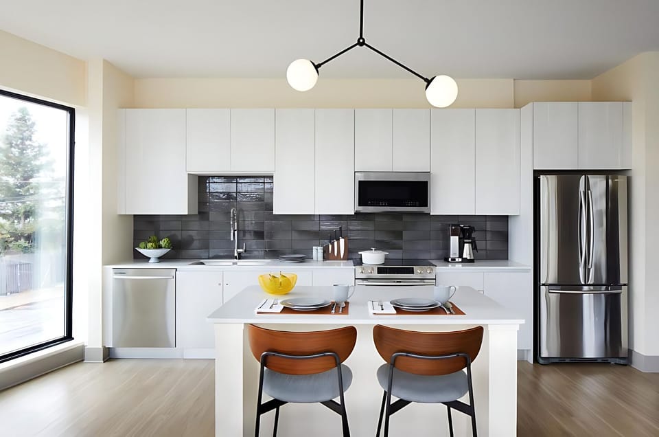 Savor breakfast at the island in a sleek modern kitchen.