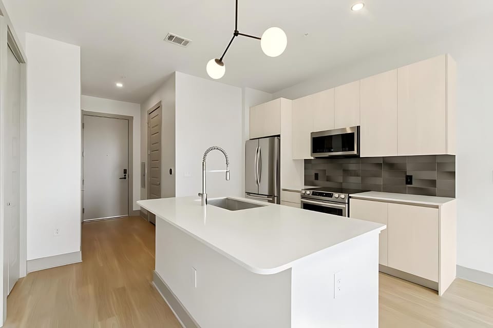 Host with ease around the oversized island and bright finishes.