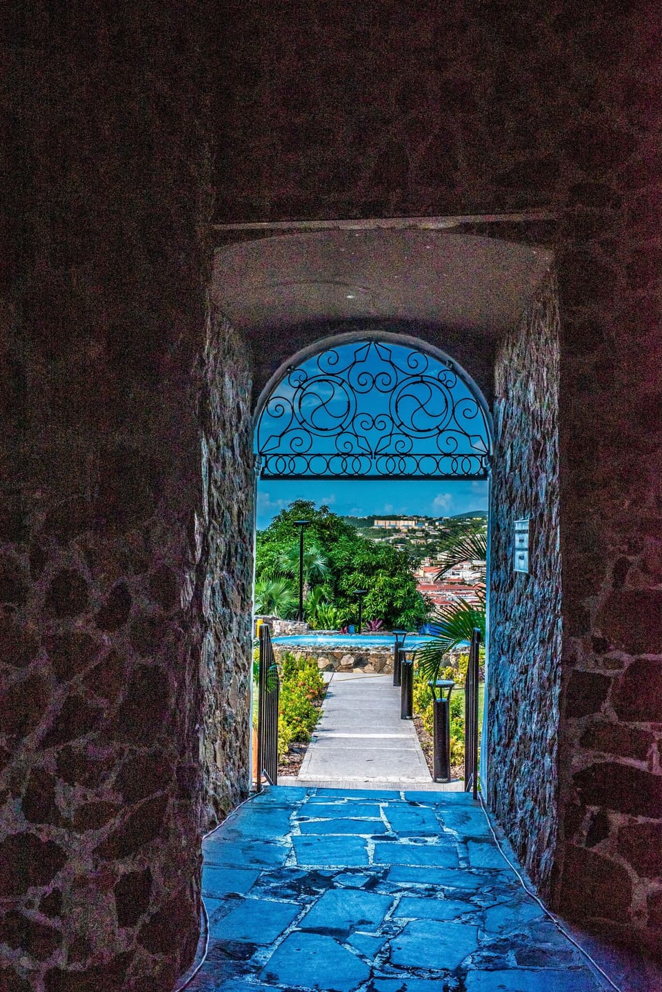 Discover historic charm with stone archways leading to lush garden paths.