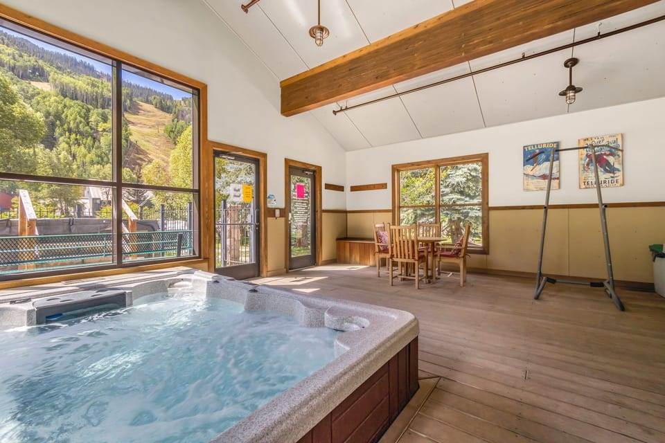 Indoor hot tub interior area with table and chairs.