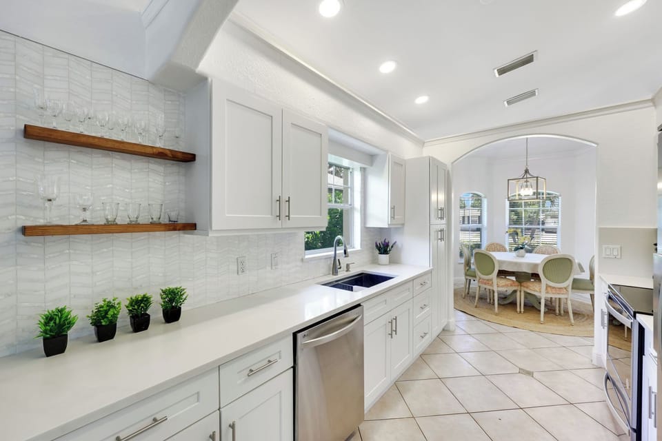 Clean countertops, stainless appliances, and a calm coastal palette make meal prep a joy