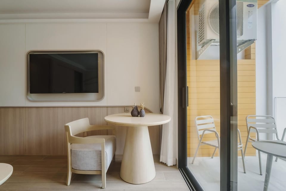 Smart TV with table and sofa in the bedroom area