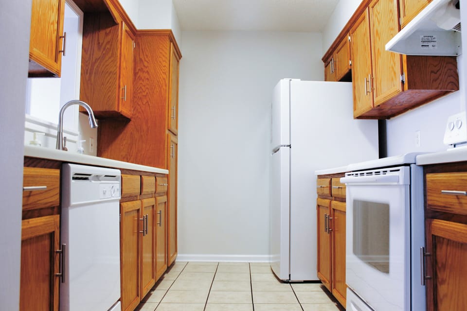 Fully equipped kitchen with cookware, dishes, silverware, and microwave.