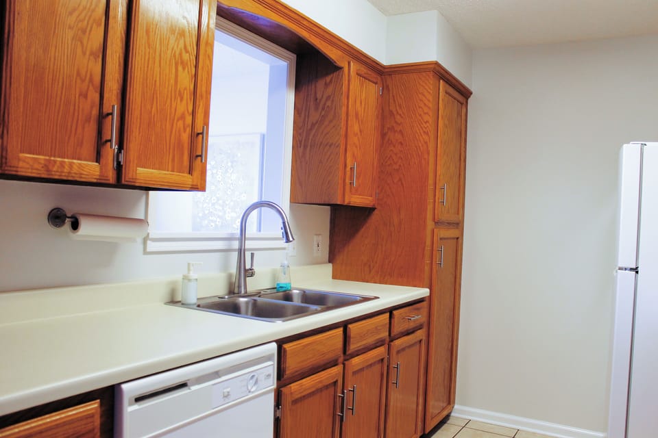 Fully equipped kitchen with cookware, dishes, silverware, and microwave.