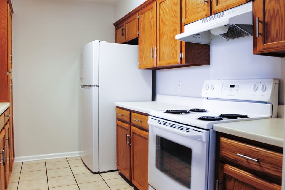 Fully equipped kitchen with cookware, dishes, silverware, and microwave.