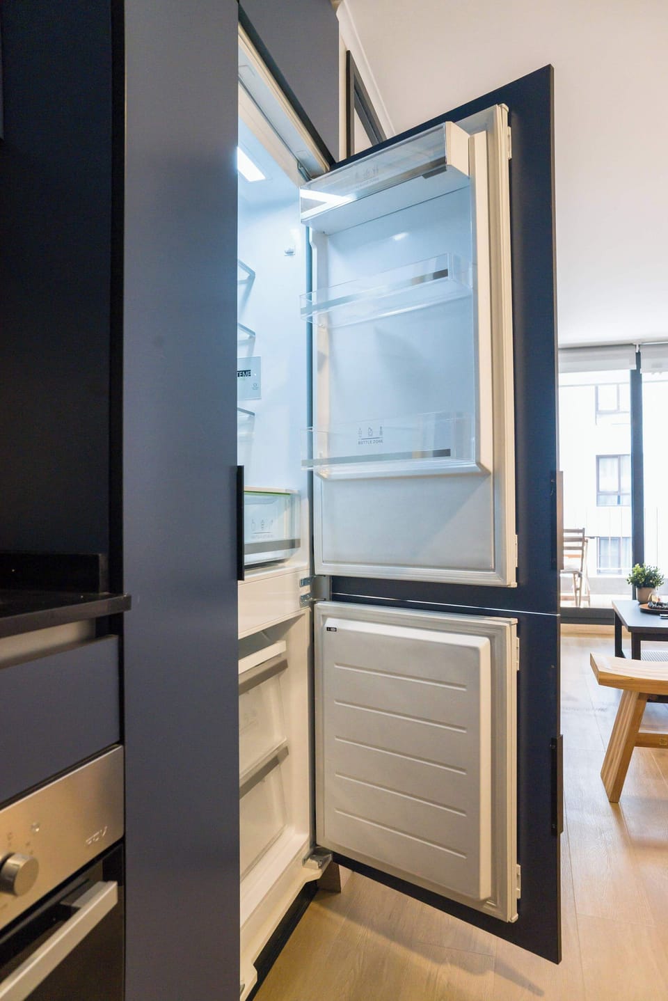 Discover the modern kitchen with sleek appliances and abundant natural light, perfect for culinary creativity.