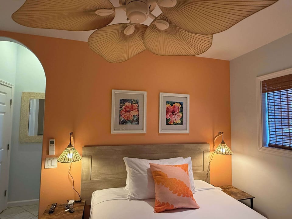 Hibiscus Room with queen bed, comfort of AC, ceiling fan, smart TV, western facing. Kitchenette and private bathroom
