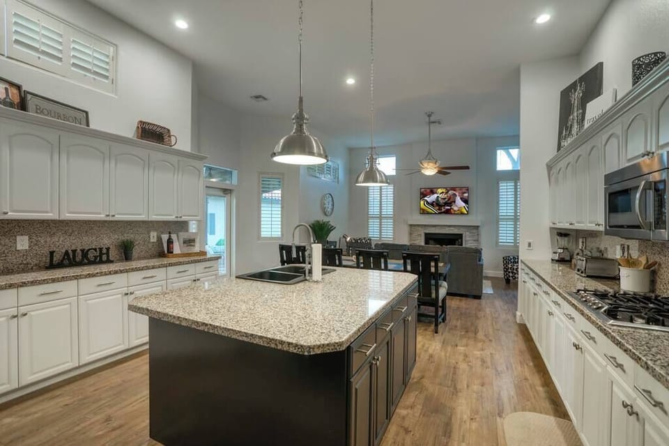 Spacious kitchen with island and long countertops.