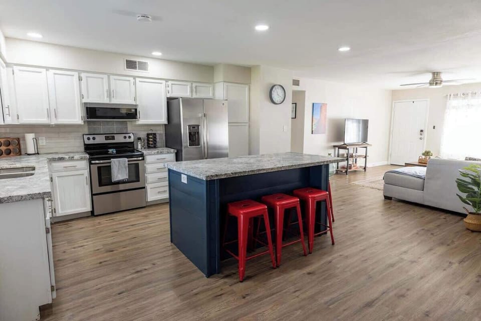 Spacious kitchen with a large island and stainless appliances.
