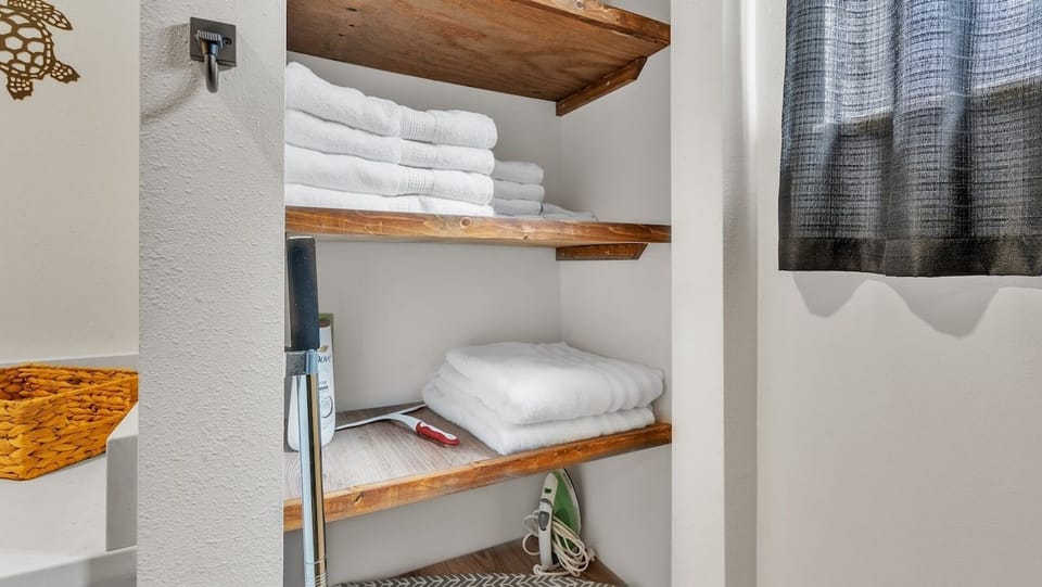 Open shelving keeps towels and linens within easy reach.