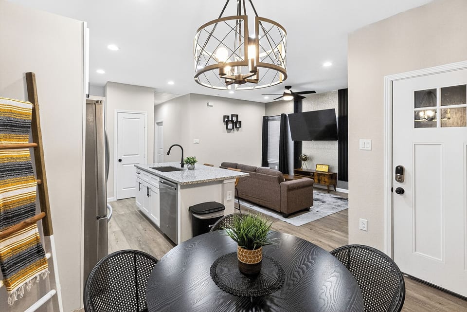 Step into this stylish and cozy living room, featuring a comfortable sofa and armchair set. The room is accented with a 65-inch TV and a black, grey and brown color theme, creating a chic and modern look. Perfect spot for relaxing and winding down.