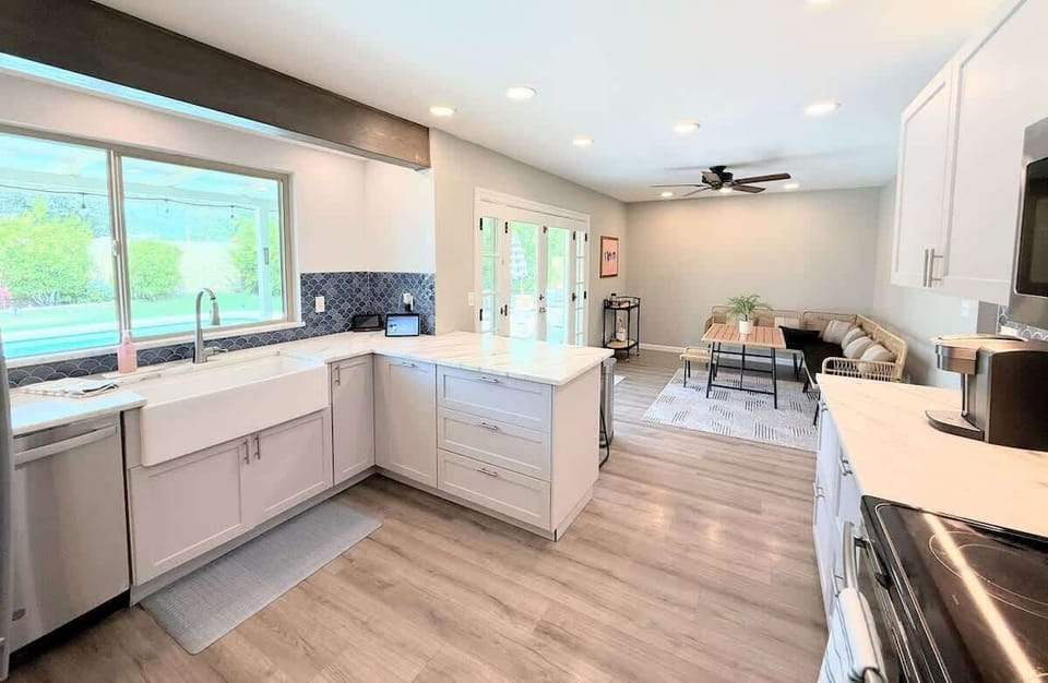 Fully stocked kitchen featuring quartz counters, large sink, and everything you need to cook and gather with family.