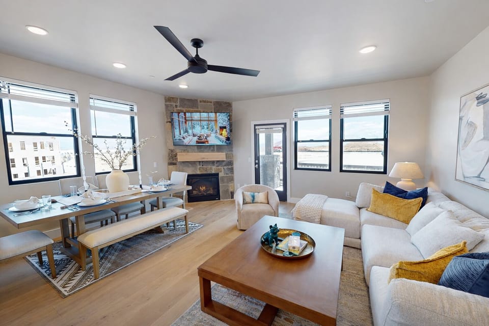 Relax in your bright open living space where modern comfort meets warmth, complete with cozy fireplace and stylish furnishings.