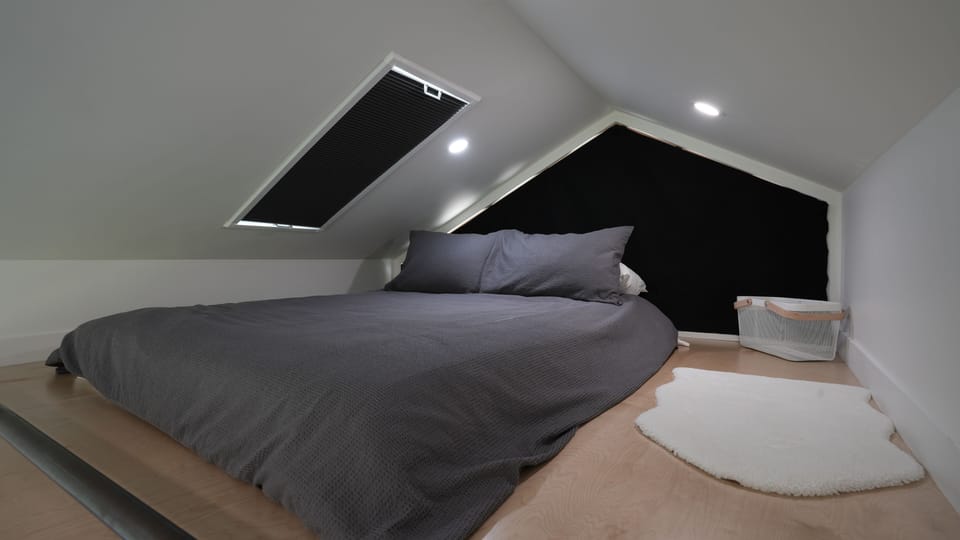 Loft queen bed w/ black-out shades for sleeping
