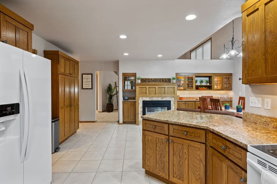 An open-concept kitchen with a dining table and a cozy fireplace creating a warm and inviting atmosphere.