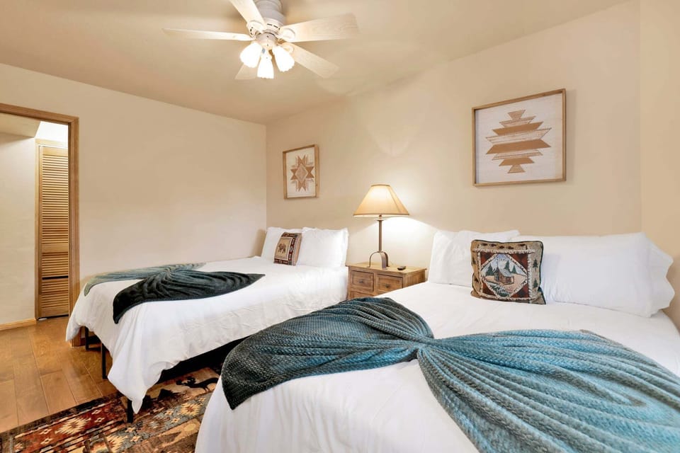 Elegant twin bed with crisp linens and inviting décor, offering a restful retreat with timeless style and cozy comfort for guests.