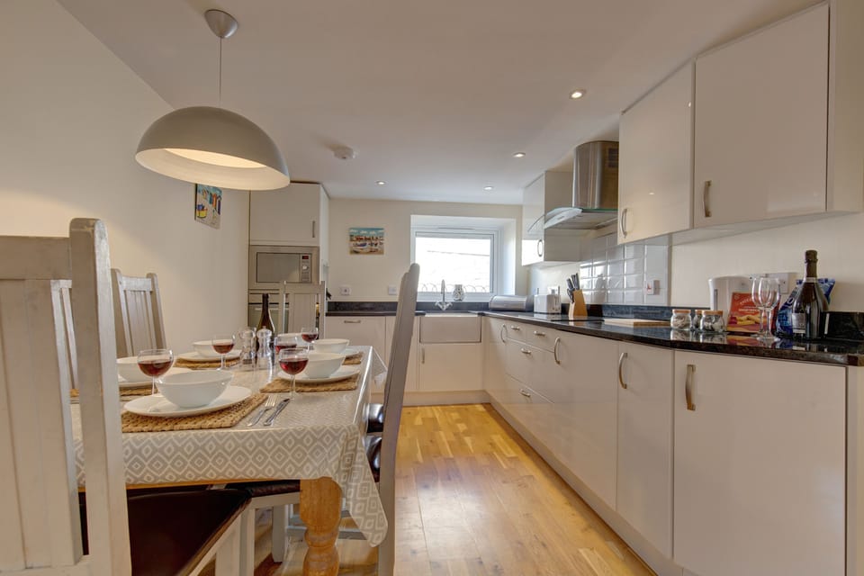 Ground floor: Kitchen area with an electric oven and hob, microwave, dishwasher and fridge