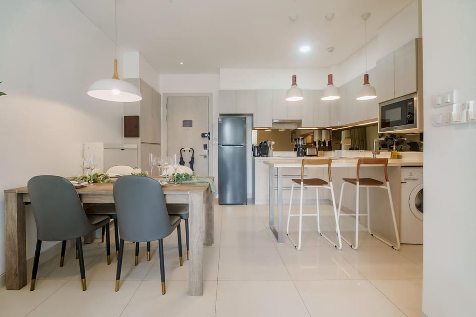 Dining area connected to a full kitchen, ideal for home cooking.