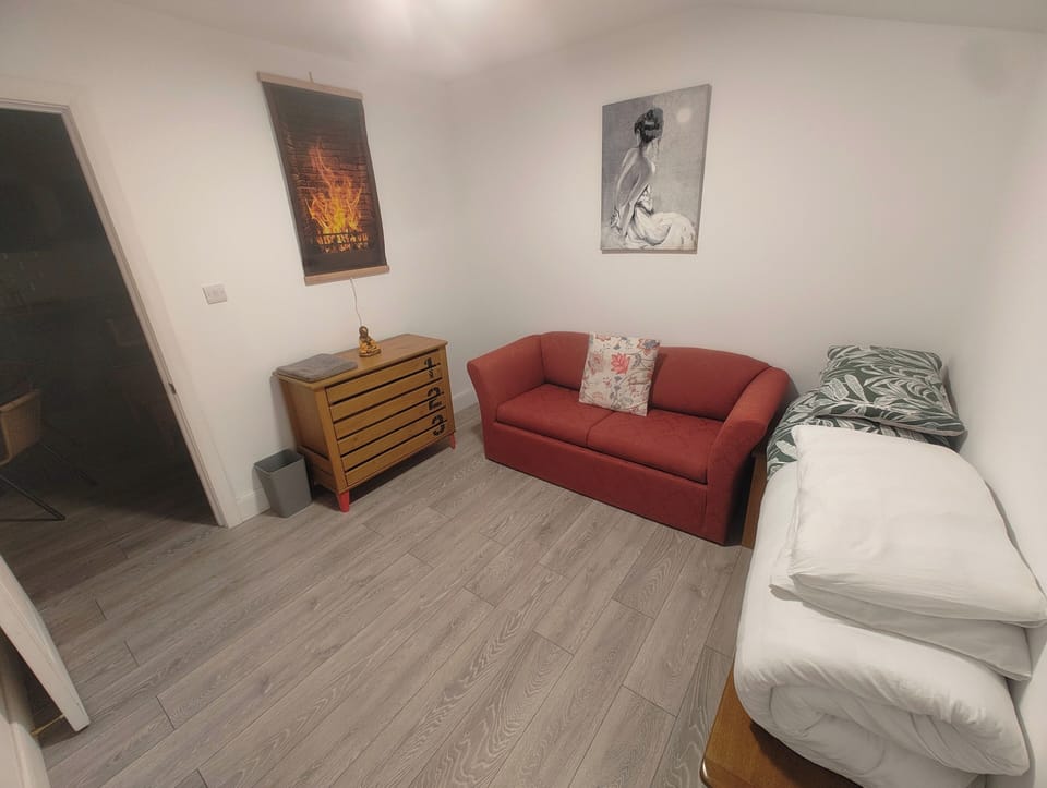 Spacious and compact bedroom with double sofabed, chest of drawers and bedside table
