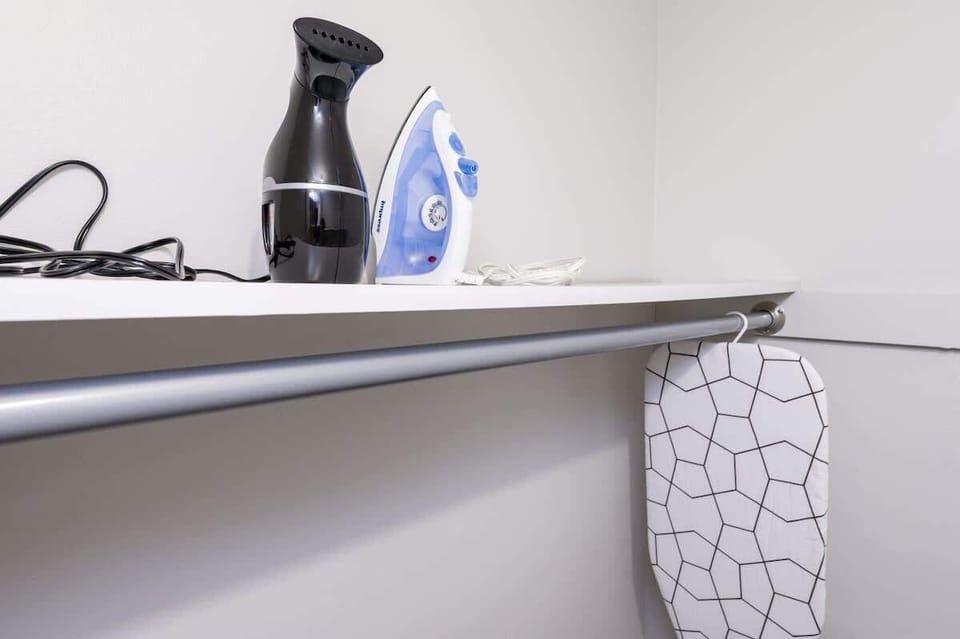 Keep your wardrobe pristine with handy ironing and steaming tools in a dedicated laundry nook