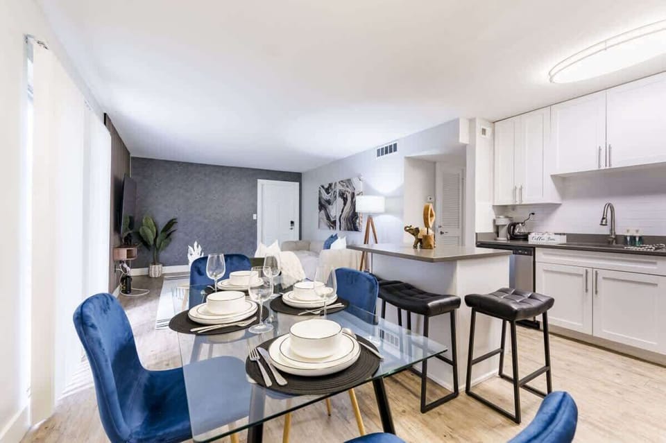 Enjoy effortless entertaining with a glass dining set, bar seating and a modern kitchen designed for both style and function