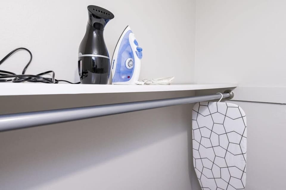 Keep your wardrobe pristine with handy ironing and steaming tools in a dedicated laundry nook