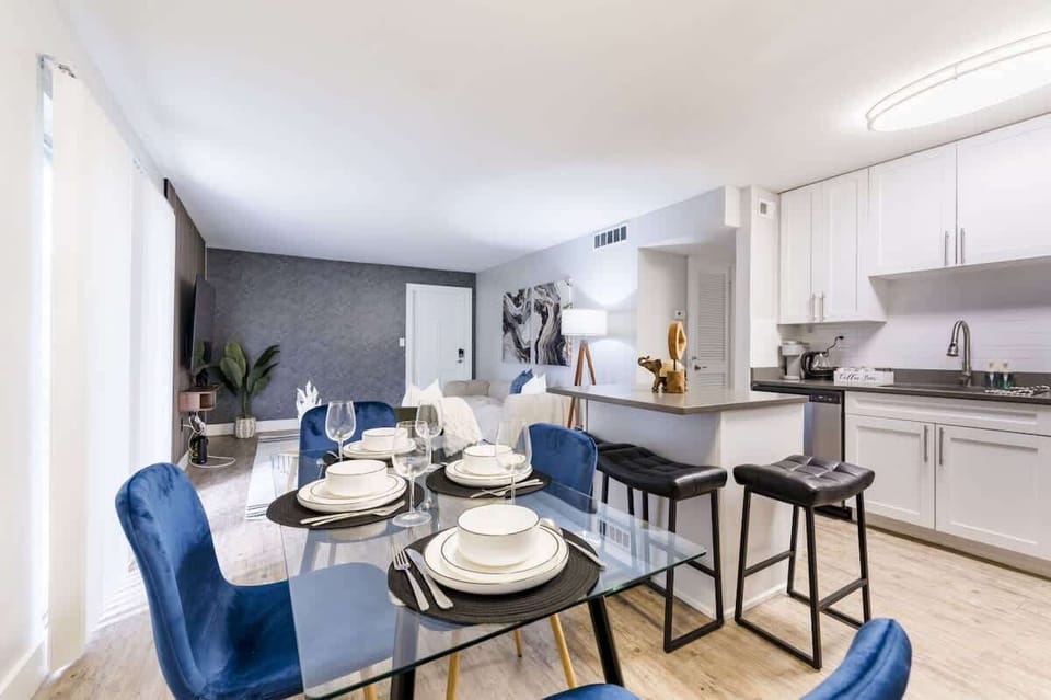Enjoy effortless entertaining with a glass dining set, bar seating and a modern kitchen designed for both style and function