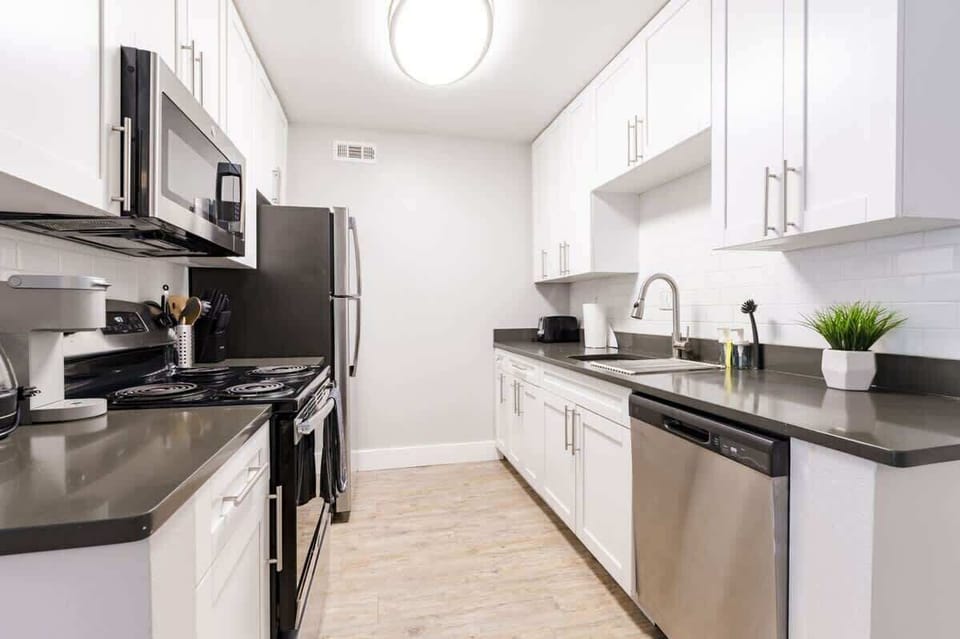 Modern galley-style kitchen with full-size stainless steel appliances, elegant finishes, and everything you need for home-cooked meals