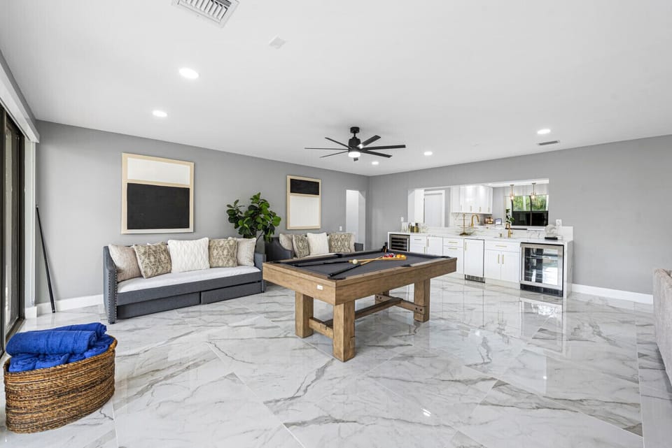 Open concept villa games area billiards plush bench and contemporary living