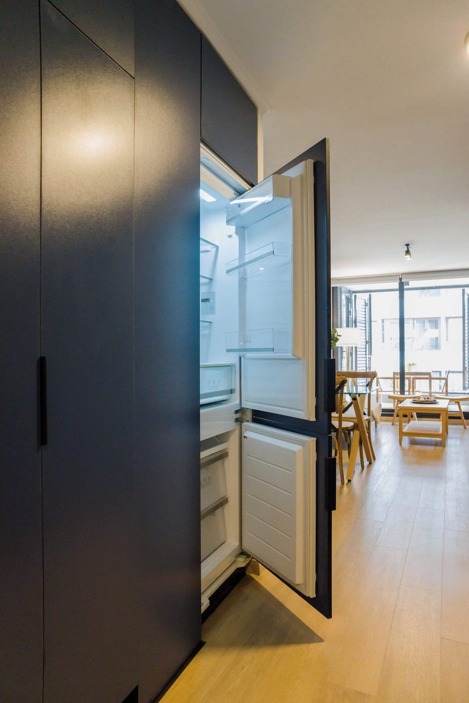 Experience culinary delight in this modern kitchen with sleek cabinetry and abundant natural light.