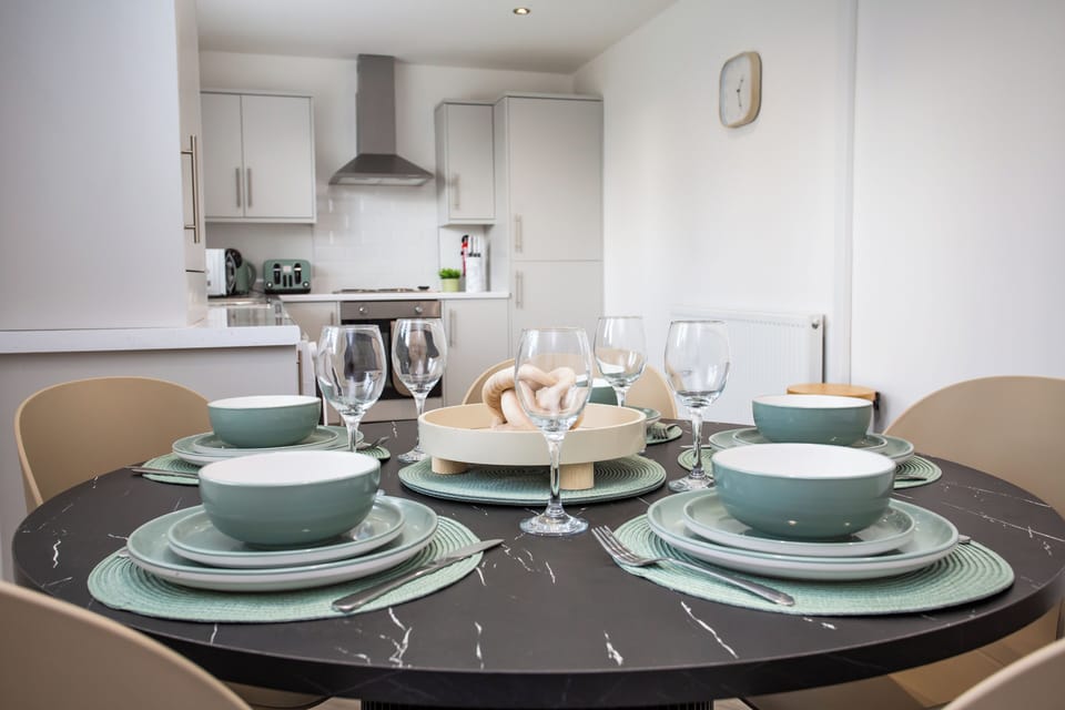 Bright dining area with a sleek kitchen just steps away