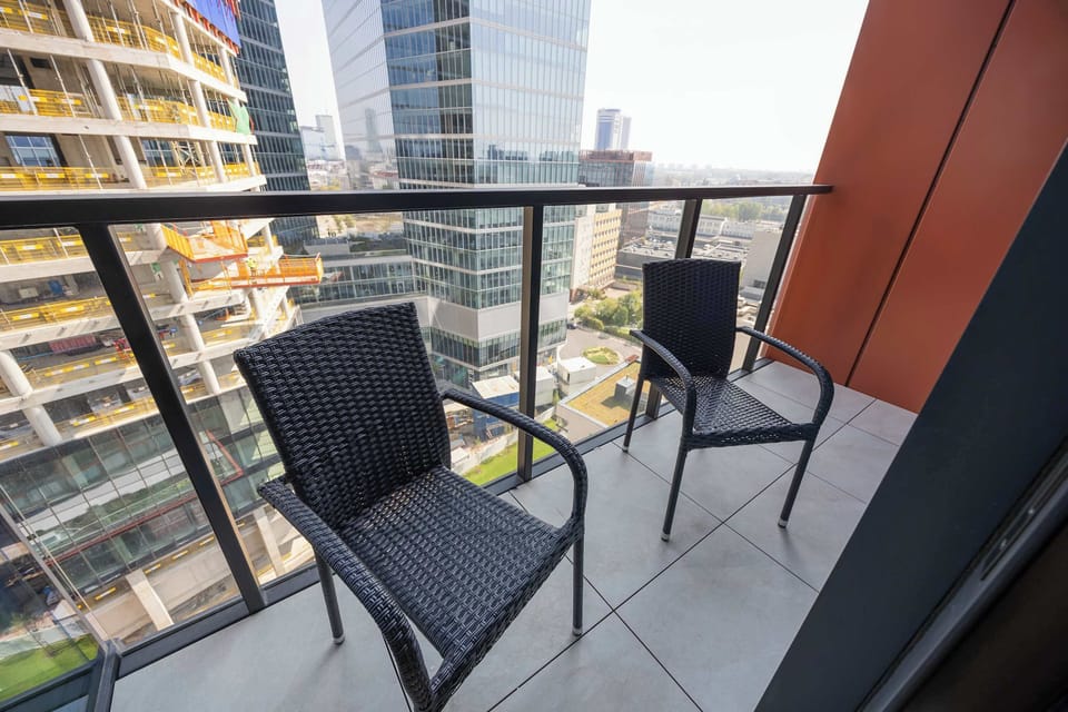 The balcony with a set of furniture is perfect for enjoying your morning coffee outdoors.