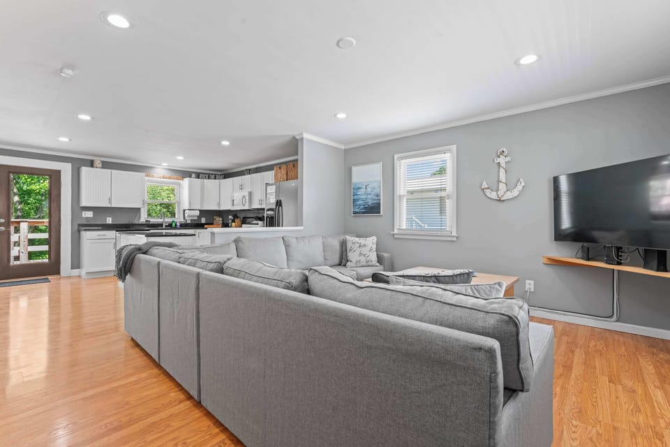 Step into a bright living room with a cozy sofa and smart TV for relaxing nights